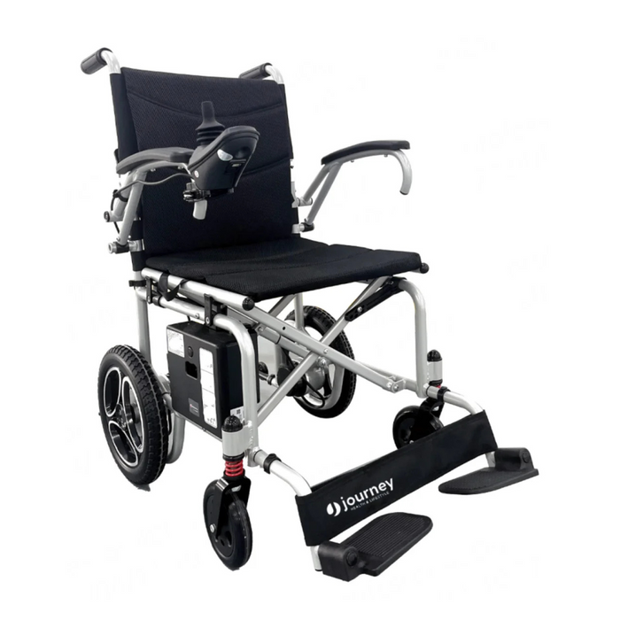 The Journey Air Lightweight Folding Powerchair, weighing only 37 lbs, is black and silver with padded armrests and a right-arm joystick. It features a footrest, large rear wheels, smaller front wheels, and a compact design for easy mobility.