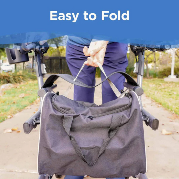 A person folds a black bag while on a path surrounded by greenery, showcasing the lightweight convenience of the Journey UPWalker® EZ Lite Rollator - Upright Rolling Walker. The phrase Easy to Fold highlights its enhanced balance and user-friendly design.