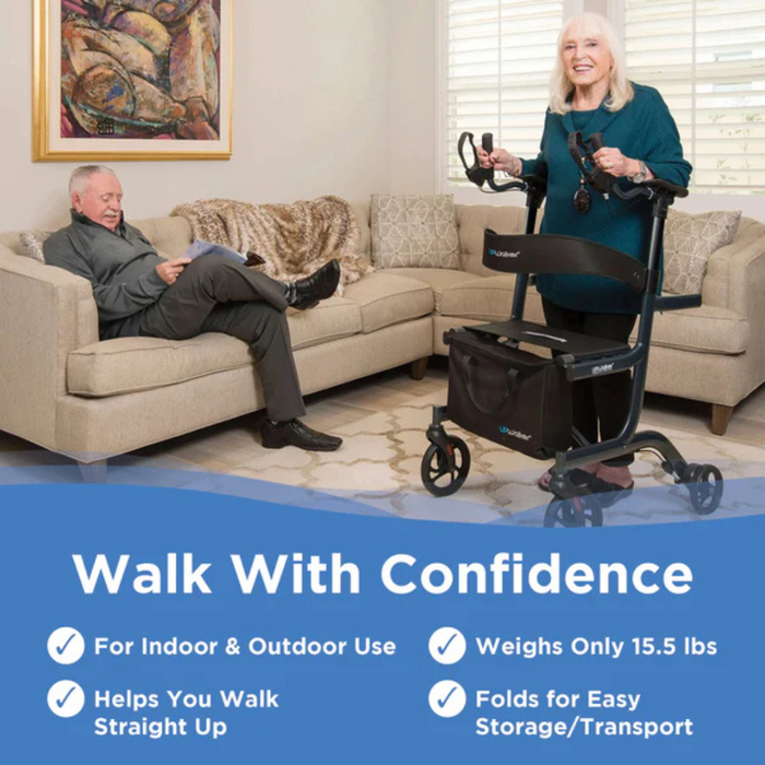 In a cozy living room, an elderly woman smiles while using the Journey UPWalker® Lite Upright Rolling Walker Rollator - Only 15 lbs. An elderly man reads on the sofa. The walker is lightweight, promotes upright posture support, suitable for indoor/outdoor use, and easily folds for storage.