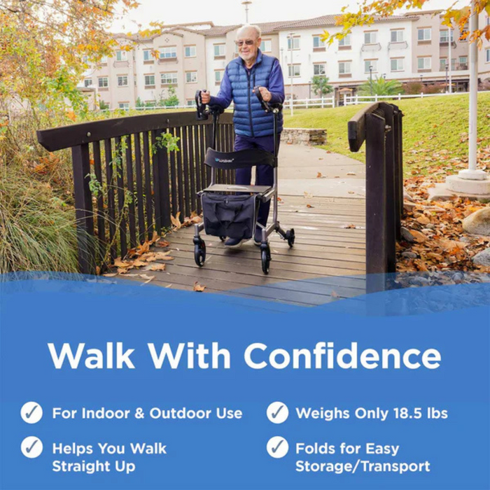 An older adult confidently walks on a wooden bridge surrounded by autumn leaves using the Journey UPWalker® Original Upright Rolling Walker Rollator. Suitable for indoor/outdoor use, it aids posture and mobility, weighs 18.5 lbs, and folds for easy storage/transport.