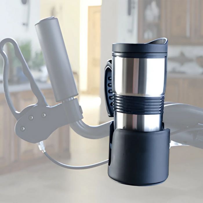 A metal travel mug, held securely in a Journey UPWalker Parts & Accessories holder attached to a bikes handlebar, mirrors the practicality of a luxury personal bag for walkers, set against a blurred indoor backdrop.