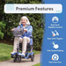 An elderly woman with white hair rides a Journey So Lite® Folding Power Scooter through a park, demonstrating its lightweight build and premium features like electronic stability control, Electronic Anti-Tip Technology, one-touch folding, and flat-free tires.