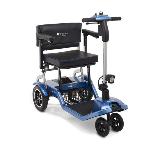 Meet the Journey So Lite® Folding Power Scooter: A lightweight, blue mobility scooter with a padded seat, black armrests, and backrest. It includes Electronic Anti-Tip Technology, a front basket, large rear wheels, smaller front wheels, and handlebar controls for safety and ease.