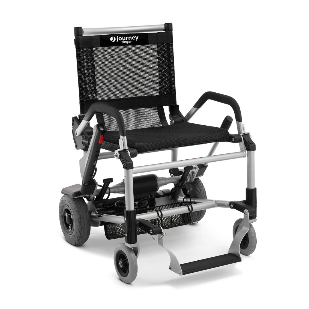 The Journey Zinger® Folding Powerchair is an FAA-approved, 49 lb black and silver lightweight electric wheelchair. It features a sleek mesh backrest with branding, armrests, foldable EV-inspired design, rear and smaller front wheels, plus a footrest.