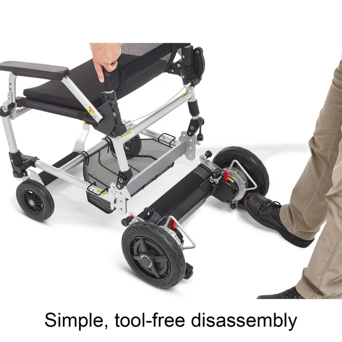 A person disassembles the Journey Zoomer® Portable Travel Powerchair, highlighting its innovative tool-free mechanism for quickly removing back wheels. The image showcases the chairs lightweight frame, folding design, and compact turning radius, emphasizing ease of disassembly.