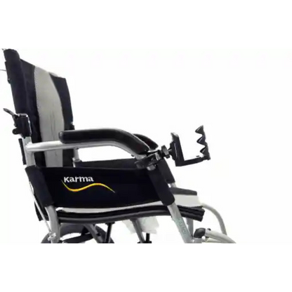 The image shows a close-up side view of a lightweight mobility device with a black fabric seat and backrest, featuring the Karma logo. It includes metal curved armrests, footrests, and an adjustable Karman Cup Holder for Mobility Aids, set against a white background.