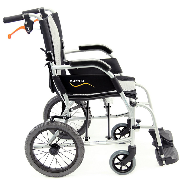 Side view of the Karman Ergo Flight Ultra Lightweight Ergonomic Transport Chair in black and silver, featuring large rear wheels, small front wheels, foldable footrests, and black armrests. Made from aircraft-grade aluminum with karma elegantly on the seat backrest.