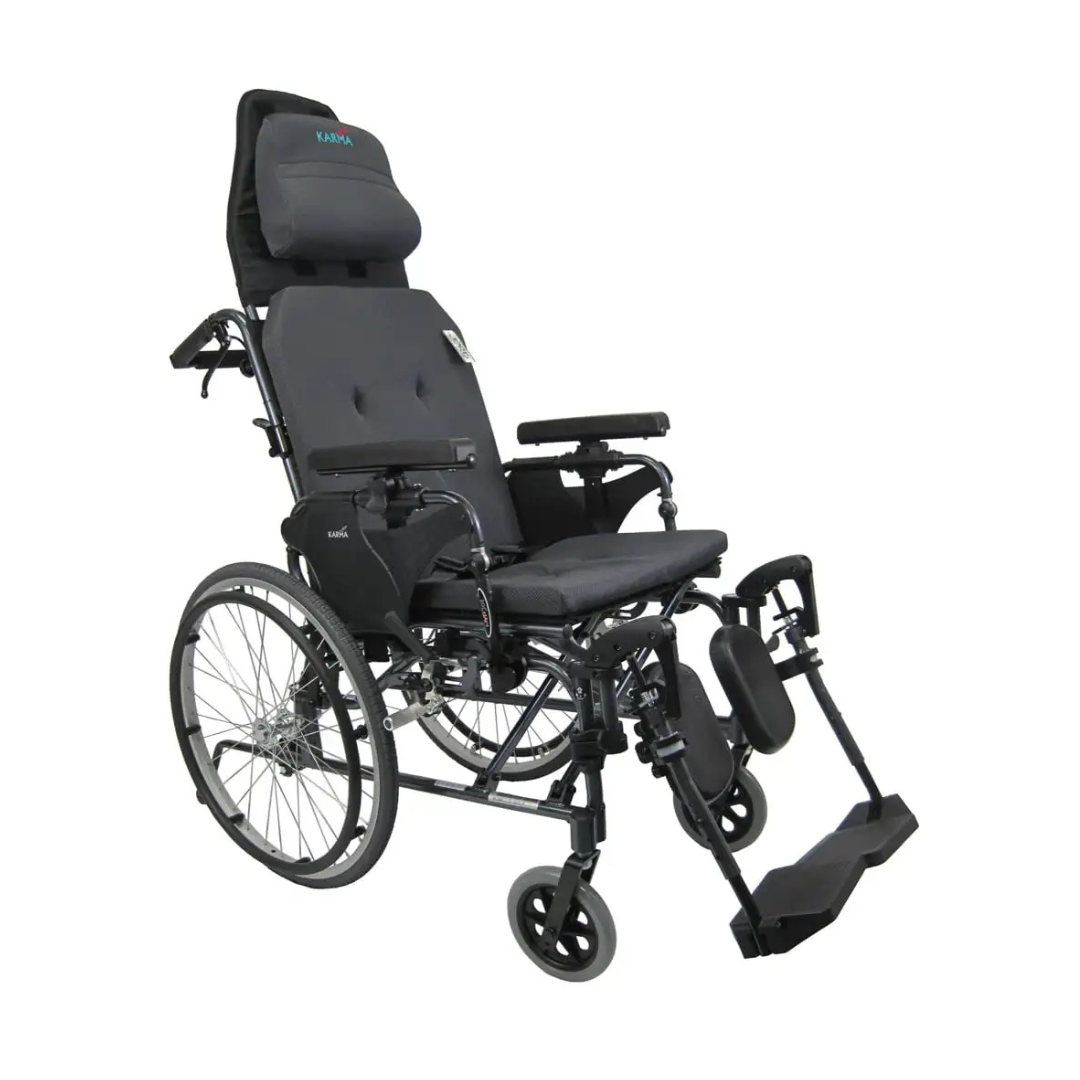 The Karman Aluminum Ultra Lightweight MVP-502 Reclining Wheelchair, featuring an ergonomic black design, large rear wheels, padded seat and headrest, elevated leg supports, and armrests, is shown against a white background.