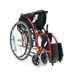 A Karman S-Ergo 105 Wheelchair in red is shown from a rear three-quarter angle, showcasing its large rear wheels, smaller front casters, and black seat with S-shaped ergonomic design. It has two fixed footrests at the front.