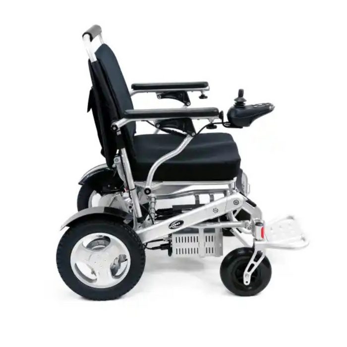 The Karman Tranzit Foldable Lightweight Power Wheelchair is silver and black with a cushioned seat, backrest, right-arm joystick control, footrest, large rear wheels, and small front wheels for enhanced mobility and comfort.