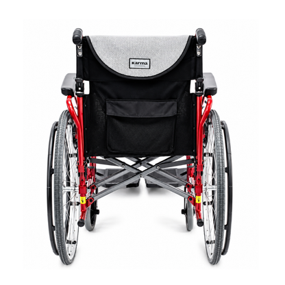 Rear view of the Karman S-Ergo 125 Ergonomic Lightweight Wheelchair with a red frame, large rear wheels, flip back arms, and black seat covering featuring the brand name Karma on the backrest.