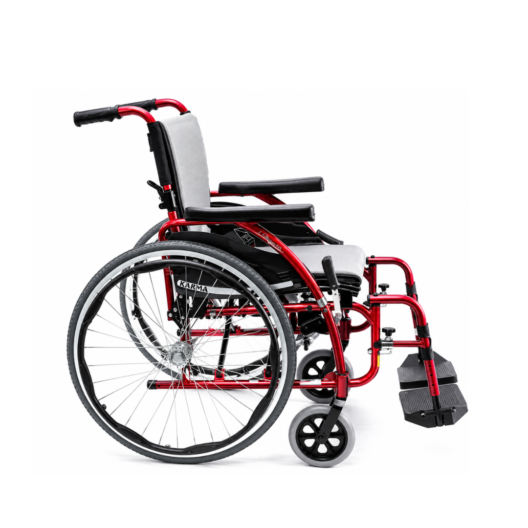 The Karman S-Ergo 125 Ergonomic Lightweight Wheelchair with Flip Back Arms, in red and black with large rear wheels, small front casters, padded armrests, and a light gray seat and backrest, is shown in profile on a white background.