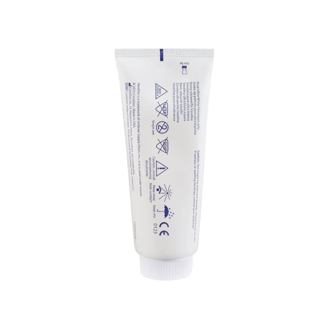A white tube labeled "Kendall Vaseline Pure Ultra White Petroleum Jelly - 3.25 oz" with blue text and safety symbols stands upright on a white background, showing warnings and product details for this skin protectant.