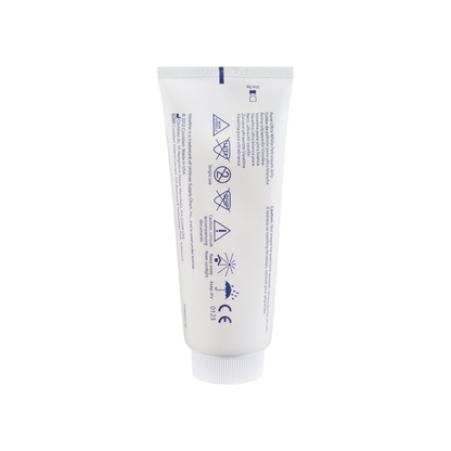 A white tube labeled "Kendall Vaseline Pure Ultra White Petroleum Jelly - 3.25 oz" with blue text and safety symbols stands upright on a white background, showing warnings and product details for this skin protectant.