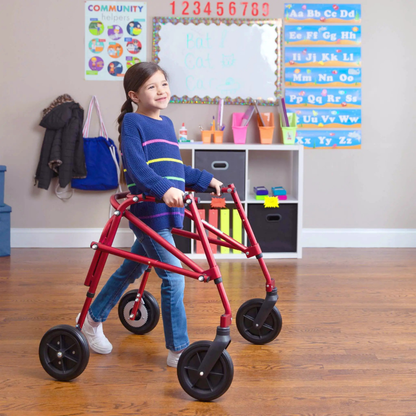 A girl walking with support from the Circle Specialty Klip Pediatric Posterior Walker.
