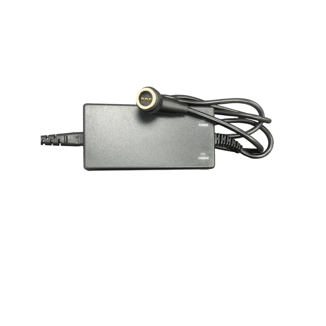 A black rectangular Lithium Battery Charger 2AH Magnetic from Monarch Mobility, featuring a round connector, attached cable, and labeled Power and Charge indicators, is displayed on a white background; this charger is compatible with the Monarch Mobility powerchair Smarti Plus.