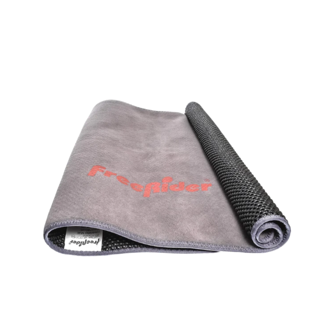 The FreeRider Mobility Loading Mat, a gray mat ideal for loading mobility scooters, is partially rolled with "Freesider" in red and a textured black underside shown at one end.