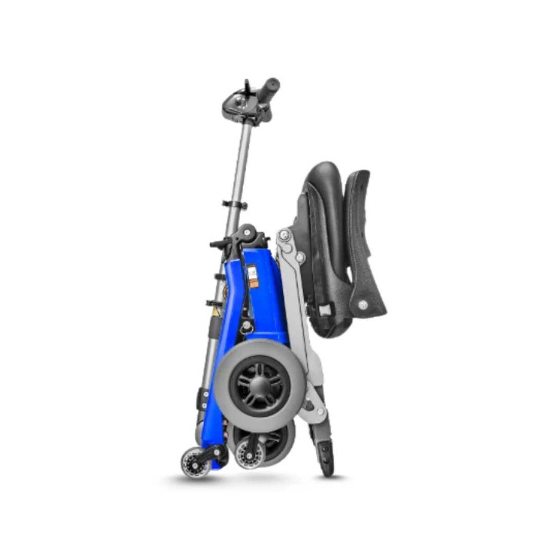 The FreeRider Luggie Standard Travel Scooter, a compact and lightweight foldable model in blue with black and gray wheels, stands upright for easy storage or transport against a plain white background.