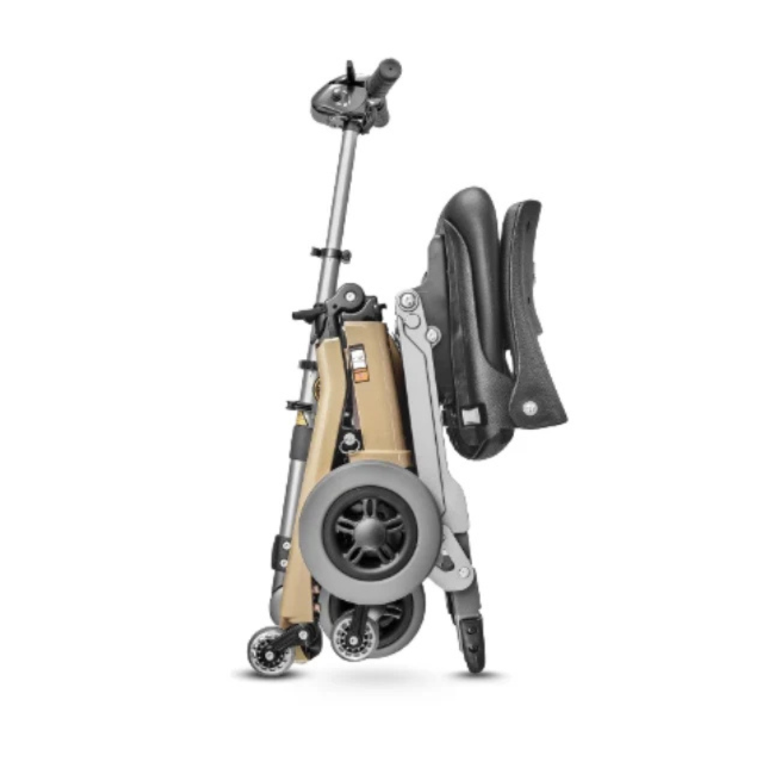 The FreeRider Luggie Standard Travel Scooter, shown fully folded upright with visible black wheels and handlebar against a white background, provides a convenient portable mobility aid for easy transport.