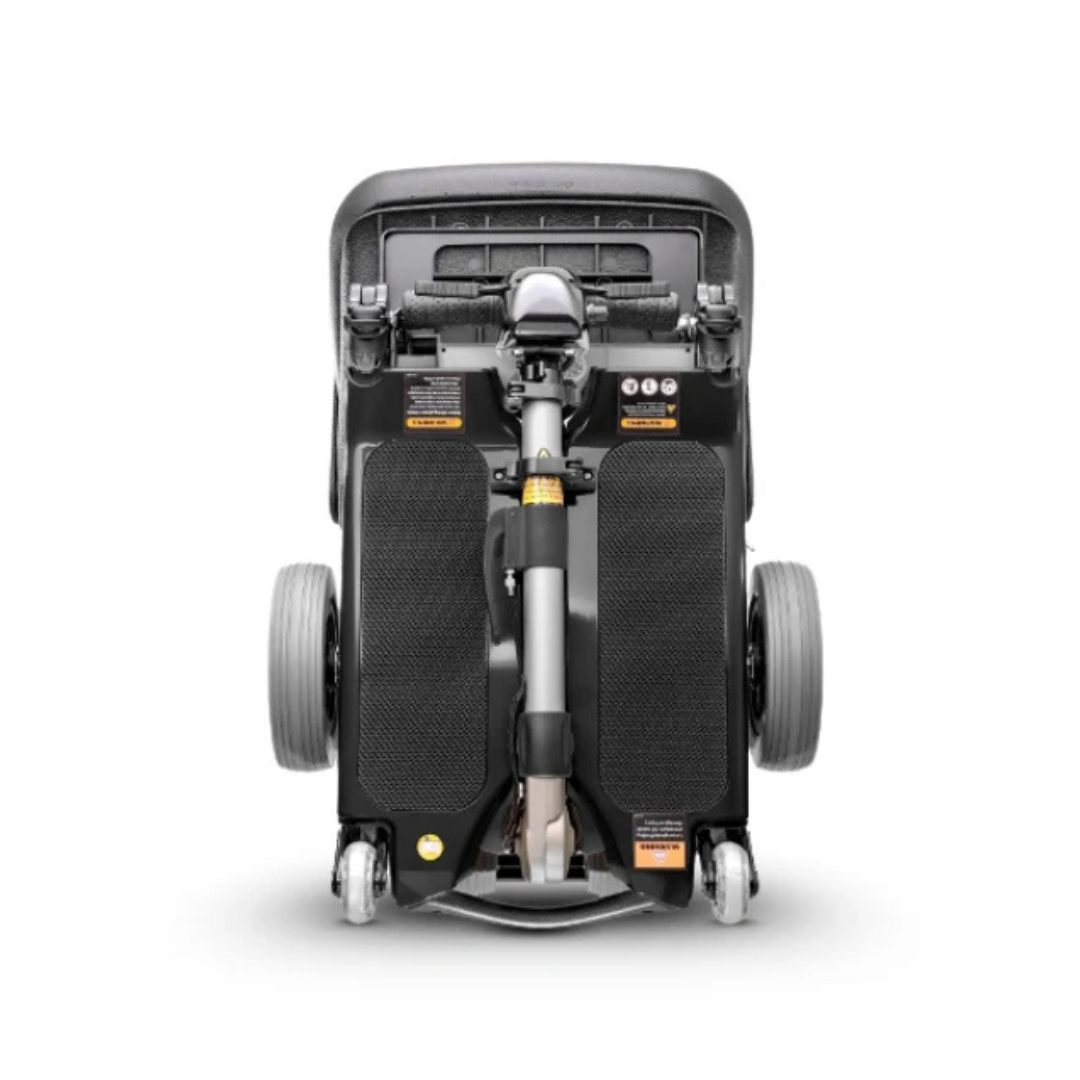 The FreeRider Luggie Standard Travel Scooter, shown folded from above in black, displays its wheels and handlebars as a compact, portable mobility aid.