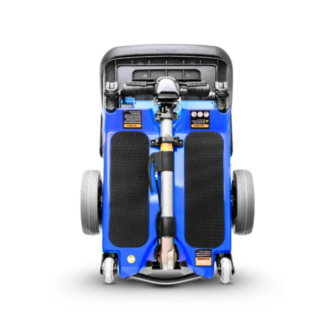 The FreeRider Luggie Standard Travel Scooter, shown upright in its compact folded form, displays its wheels, handlebars, and footrests against a white background.