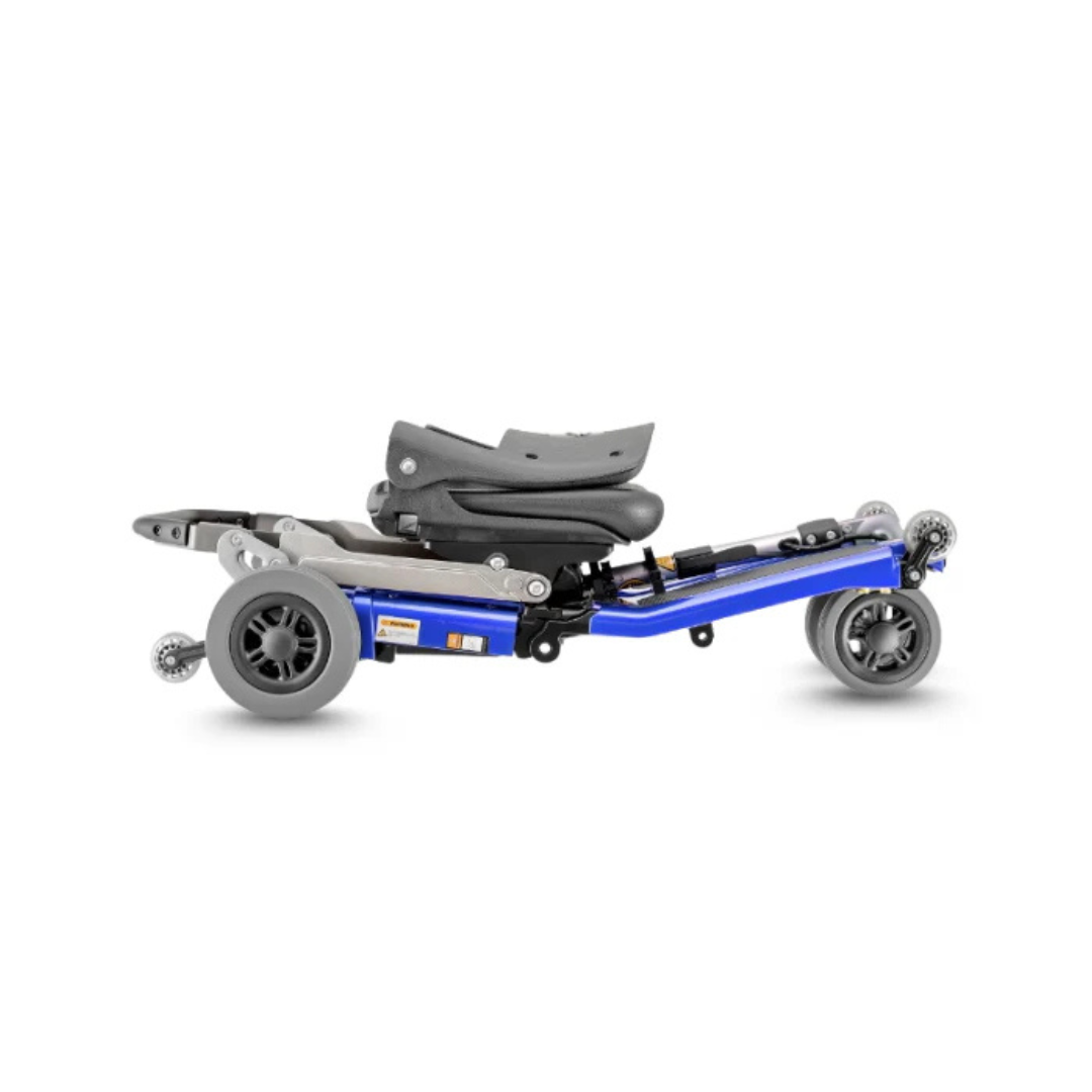 The FreeRider Luggie Standard Travel Scooter folds flat, with its blue and black seat, wheels, and frame compactly aligned for effortless transport or storage.
