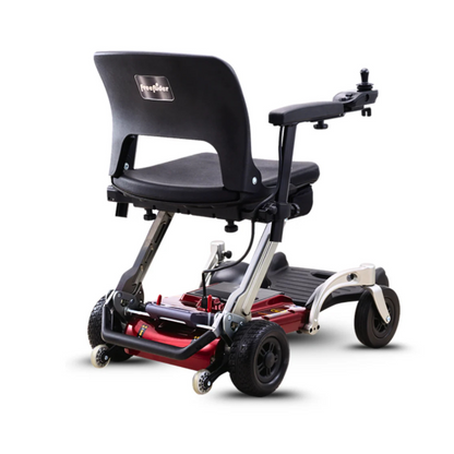 The FreeRider Luggie Travel Lightweight Powerchair features a sleek red and silver compact frame, black cushioned seat with armrests, and four wheels, shown from the back against a white background.