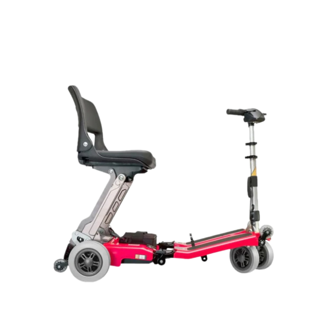 The FreeRider Luggie Classic II Travel Scooter, a compact, airline-approved four-wheel scooter with a black seat, silver frame, red base, and handlebars, is displayed against a white background.