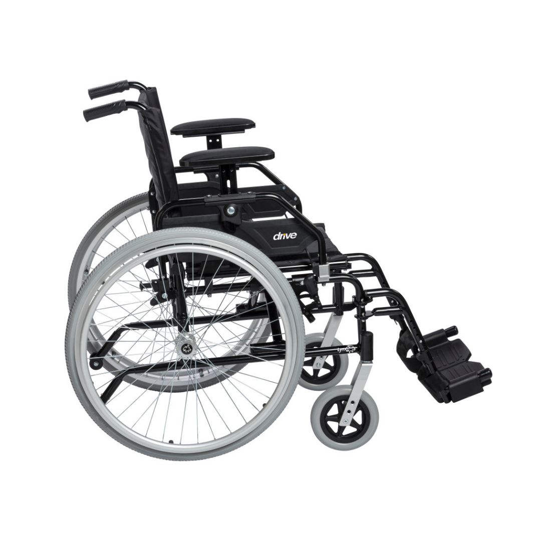 The Drive Lynx Ultra Lightweight Portable Wheelchair, featuring large quick-release rear wheels, small front wheels, armrests, and footrests, is shown from the side on a white background.