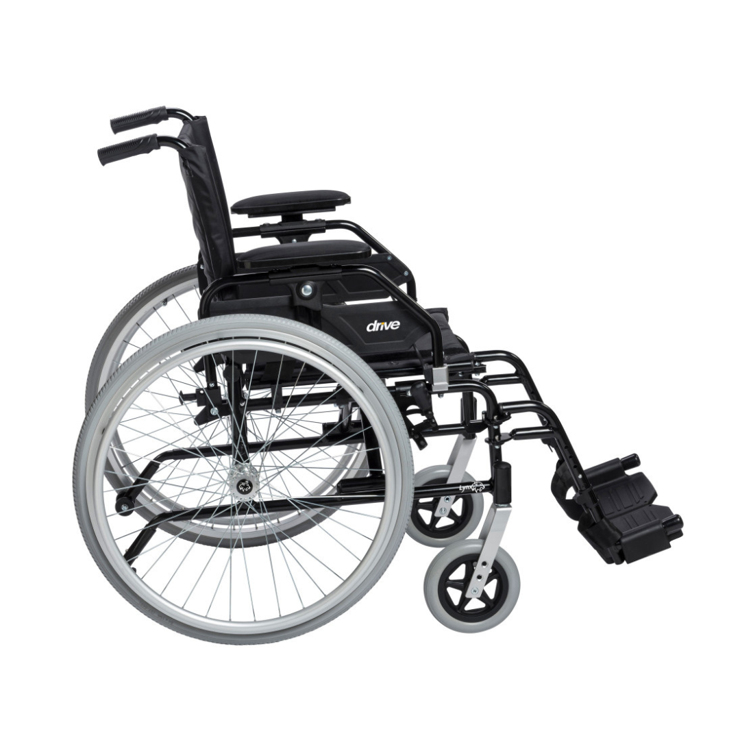 The Drive Lynx Ultra Lightweight Portable Wheelchair is black, has large rear wheels, small front wheels, quick-release wheels, footrests, and a cushioned seat and backrest with the "drive" brand visible on the side.