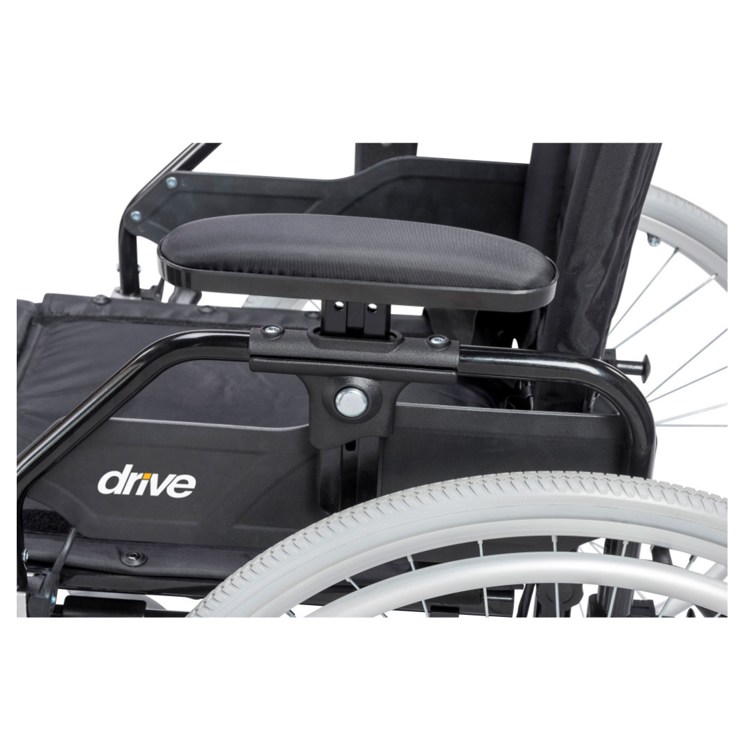 Close-up of the Drive Lynx Ultra Lightweight Portable Wheelchair, featuring the armrest, seat section, and large rear wheel with quick-release mechanism; "drive" branding is visible on the side panel.