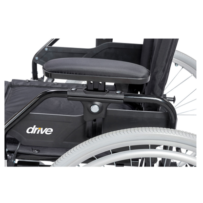 Close-up of the Drive Lynx Ultra Lightweight Portable Wheelchair, featuring the armrest, seat section, and large rear wheel with quick-release mechanism; "drive" branding is visible on the side panel.