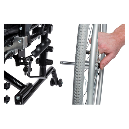 A hand operates the quick-release wheels of the Drive Lynx Ultra Lightweight Portable Wheelchair, demonstrating the convenient release mechanism on both the wheel hub and wheelchair frame.