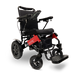 The ComfyGo MAJESTIC IQ-9000 is a black and red remote-controlled electric wheelchair featuring a cushioned seat with armrests and a footrest. It is designed with large rear wheels and smaller front ones for stability. A joystick controller on the armrest facilitates smooth navigation, while the word "Majestic" is elegantly printed on its lightweight frame.