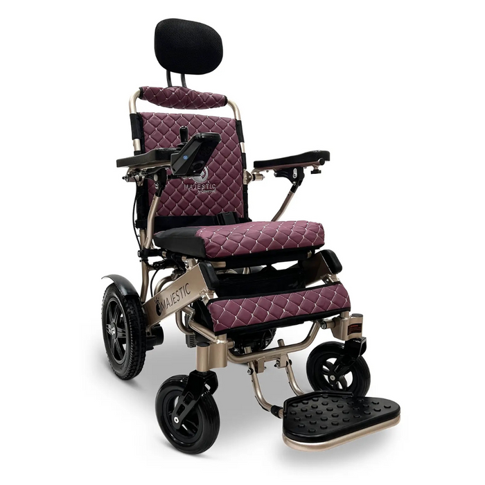 The ComfyGo MAJESTIC IQ-9000 Auto Folding Electric Wheelchair is sleek in maroon and black, featuring padded headrests, armrests, footrest, quilted fabric upholstery, sturdy wheels for mobility, a digital joystick controller, and brushless silent motors for a smooth ride.