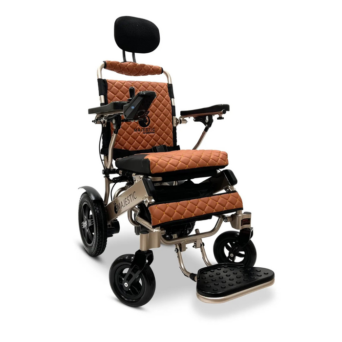 The ComfyGo MAJESTIC IQ-9000 is a luxurious brown quilted electric wheelchair with black padding, featuring a digital joystick controller, headrest, control panel, footrest, and silent brushless motors. Designed for comfort and mobility with sturdy wheels and metallic accents.