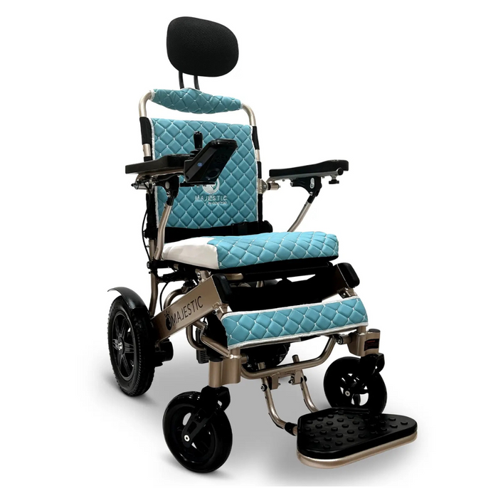 The ComfyGo MAJESTIC IQ-9000 Auto Folding Electric Wheelchair features a blue and silver design with a quilted seat, backrest, headrest, foot platform, armrest joystick controller, and smooth brushless silent motors. MAJESTIC is elegantly printed on the lower frame.