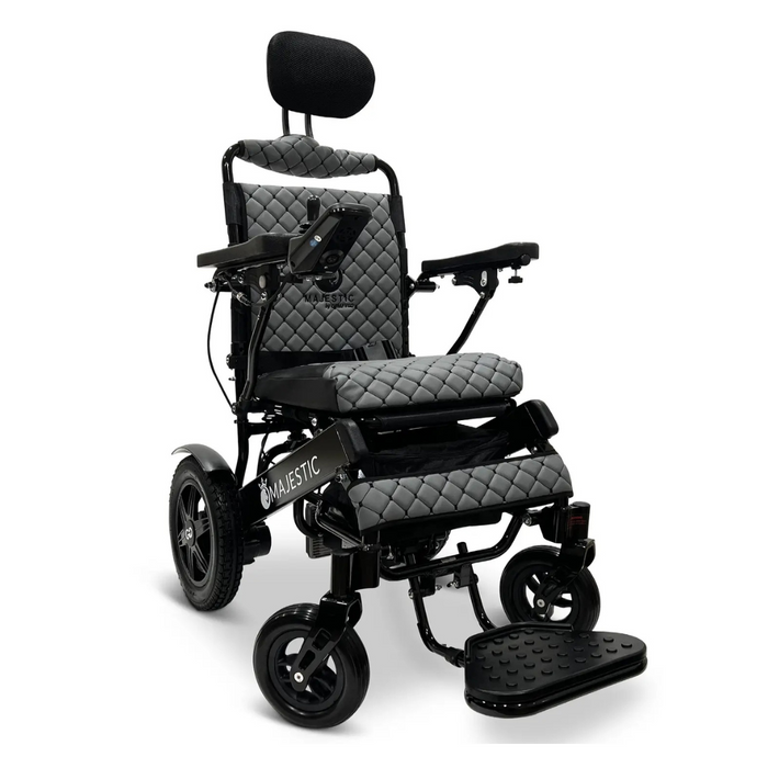 The ComfyGo MAJESTIC IQ-9000 Auto Folding Electric Wheelchair in black features quilted grey cushioning, brushless silent motors, armrests, large rear wheels, smaller front wheels, a headrest, a footplate, and a digital joystick controller mounted to the right armrest for smooth operation.