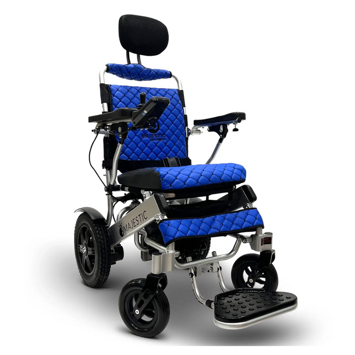 The ComfyGo MAJESTIC IQ-9000 Auto Folding Electric Wheelchair features a blue quilted seat and backrest, digital joystick controller, black headrest, armrest controls, footplates, and a metallic frame on four wheels designed for stability and comfort.