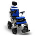 The ComfyGo MAJESTIC IQ-9000 Auto Folding Electric Wheelchair features a blue quilted seat and backrest, digital joystick controller, black headrest, armrest controls, footplates, and a metallic frame on four wheels designed for stability and comfort.