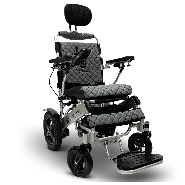 The ComfyGo MAJESTIC IQ-9000 is a sleek black and silver power wheelchair with quilted seat and backrest padding, featuring automatic reclining, detachable headrest, armrests, footrest, brushless silent motors for smooth operation, and a digital joystick controller for precise maneuverability.