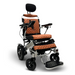 The ComfyGo MAJESTIC IQ-9000 Auto Folding Electric Wheelchair features brushless silent motors, a quilted brown leather seat with headrest, armrests, footrest, and black wheels on a silver frame. Its digital joystick controller ensures precision, and the Majestic name stands out on the sides.