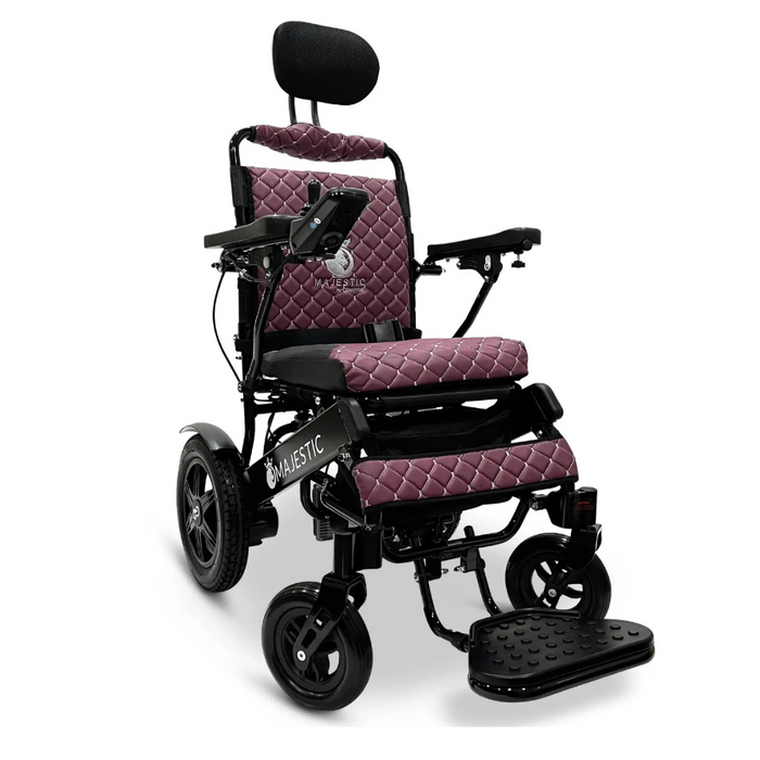 The ComfyGo MAJESTIC IQ-9000 Auto Folding Electric Wheelchair features purple quilted upholstery, a sleek black frame, an adjustable headrest, large rear wheels, armrests for comfort, a digital joystick controller, and Majestic branding on the seat and side.