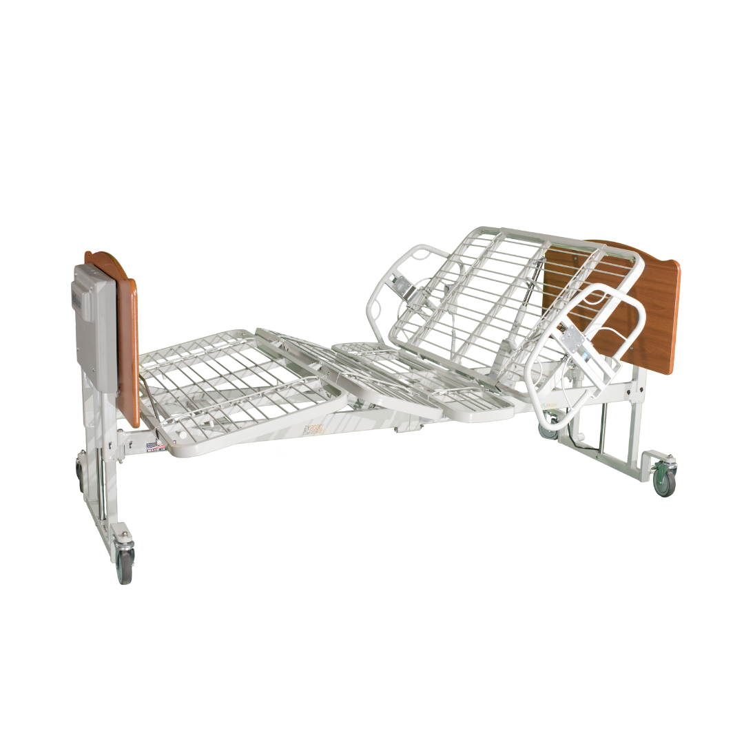 The Med-Mizer EX8000 ComfortWide Bariatric Width Adjusting Electric Bed features adjustable head and knee sections, metal rails, wooden head and footboards, and wheels for mobility. Shown partially elevated for comfort.