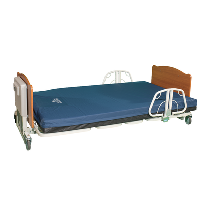 The Med-Mizer EX8000 ComfortWide Bariatric Width Adjusting Electric Bed features a blue mattress, wooden headboard and footboard, adjustable metal side rails, and wheels for mobility, displayed in a lowered position against a white background.