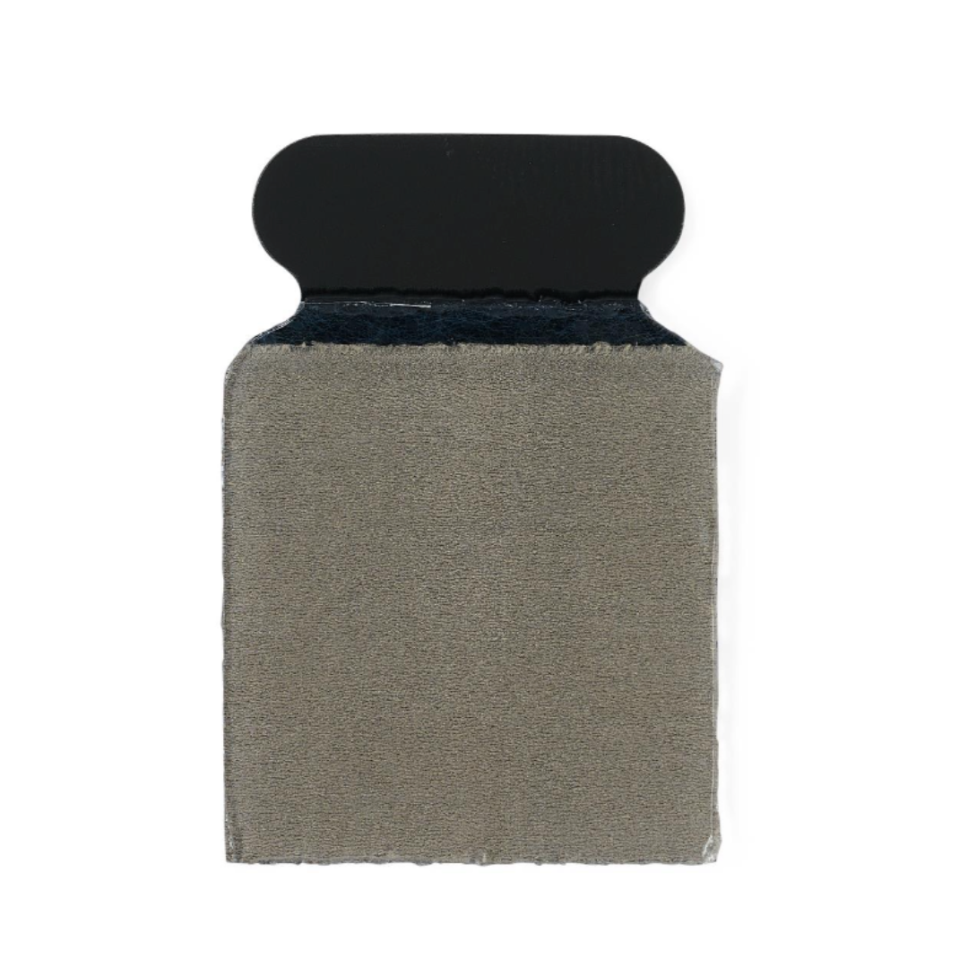 A close-up of a rectangular beige fabric swatch with a black top tab on a white background, resembling the precision and look of Medline MedGel EKG/ECG Resting Tab Electrodes.