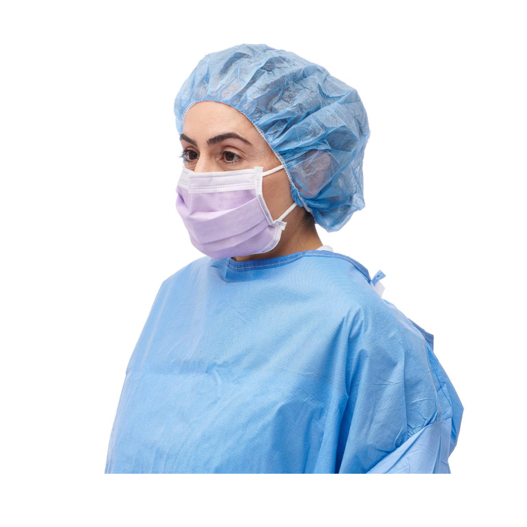 A medical professional wearing a blue surgical gown, blue hair cover, and a Medline ASTM Level 3 Procedure Face Mask with Ear Loops, looking to the left, isolated on a white background.