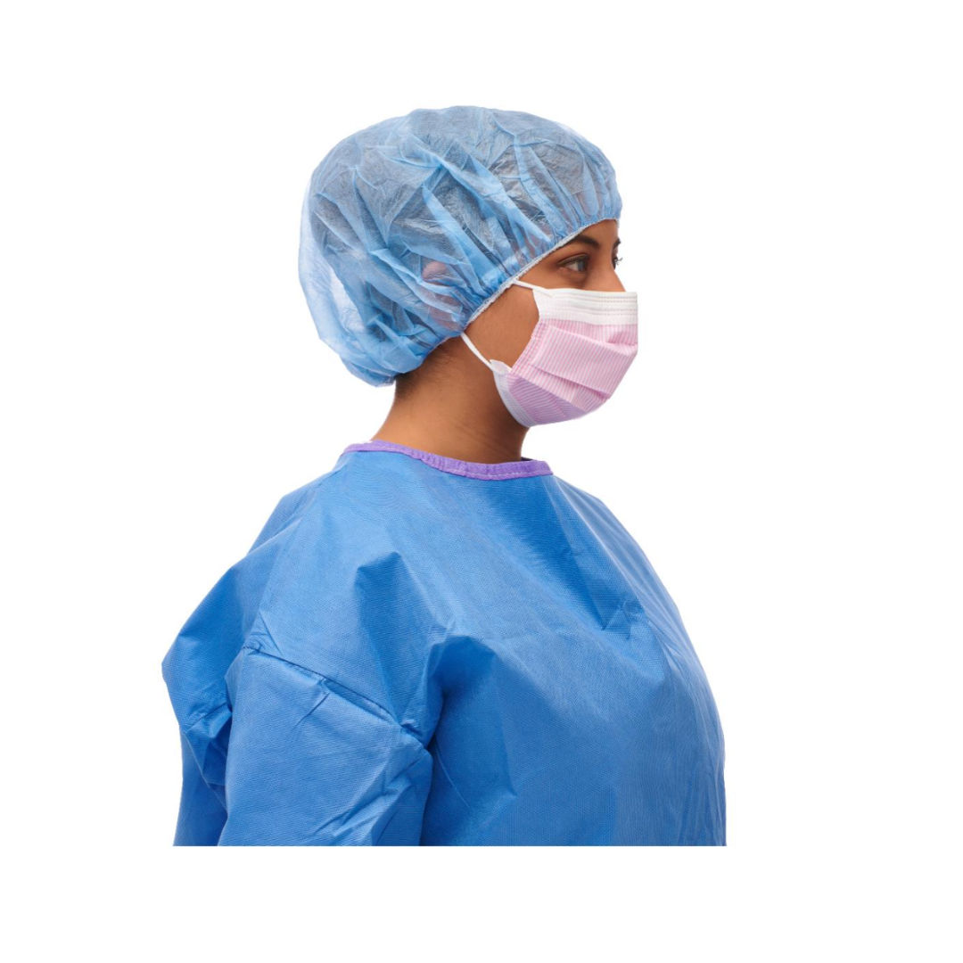 A person in a blue surgical gown and cap wears a Medline ASTM Level 3 Procedure Face Mask with ear loops, shown in profile against a white background.