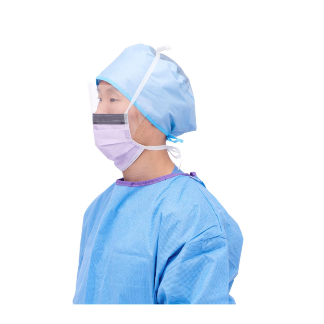 A person wearing a blue surgical gown, cap, and Medline ASTM Level 3 Surgical Face Mask with Eye Shield is shown from the side against a white background.