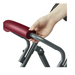 A hand grips the red handle of a gray Medline Steel Rollator with Microban, highlighting its cushioned design for comfort and antimicrobial protection, emphasizing both functionality and safety.